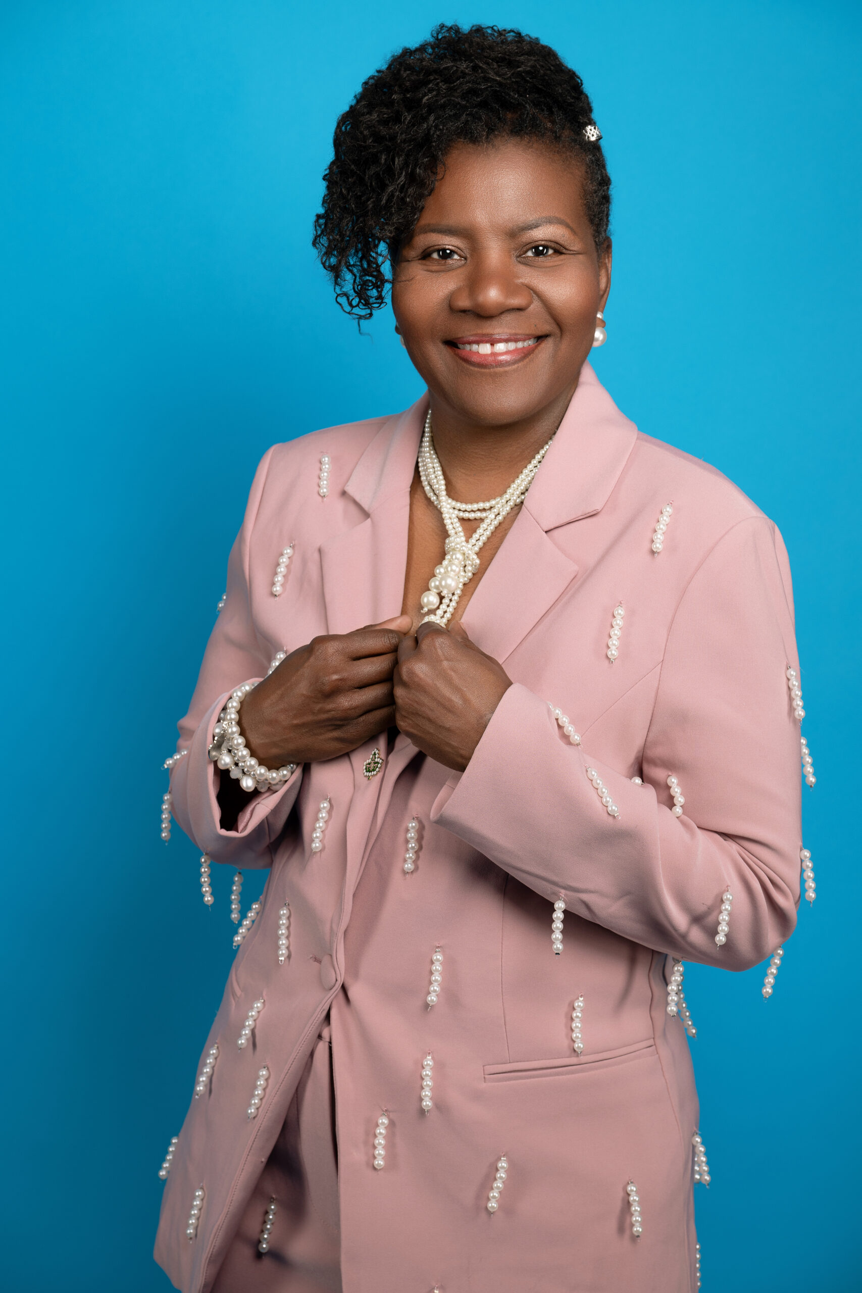 Dana J. Love, founder of Head 2 Toe Change LLC, wearing a pink suit